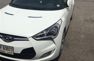 Lady driven white 2014 Hyundai Veloster